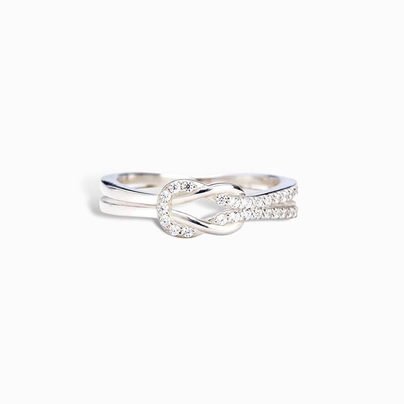 Sparkling crossover ring on finger

