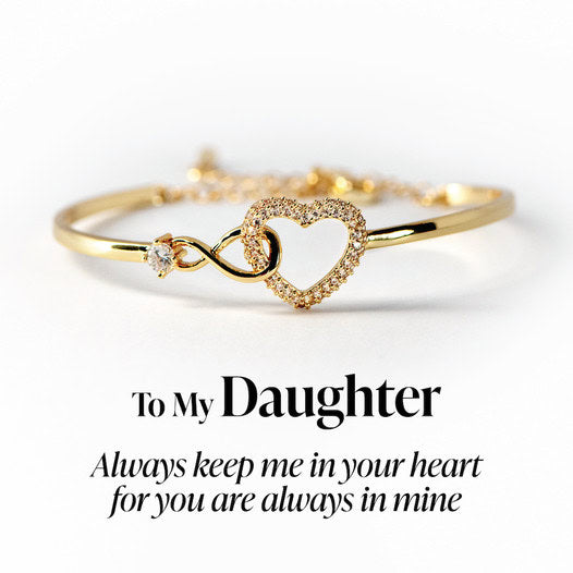 Gold bracelet with heart and infinity symbol on a white background with text 'To My Daughter Always keep me in your heart for you are always in mine'.