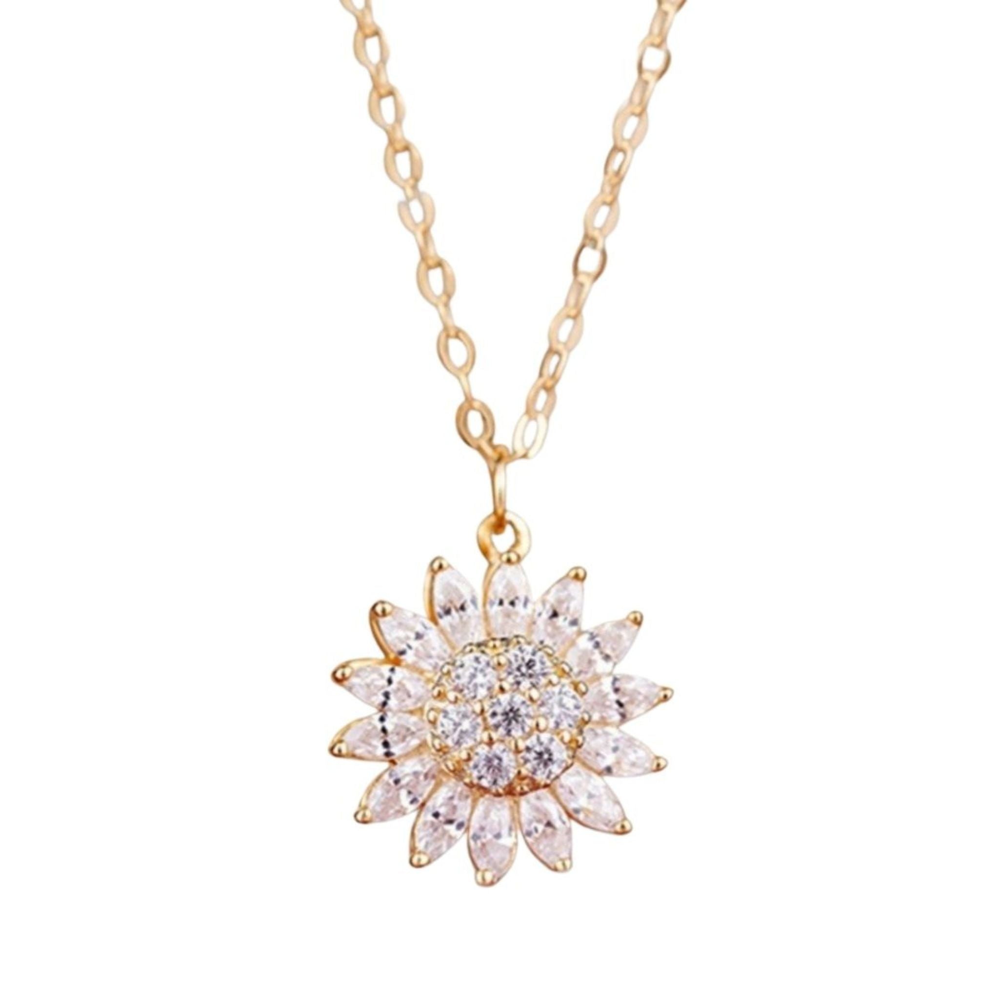 Gold necklace with a star-shaped pendant on a white background