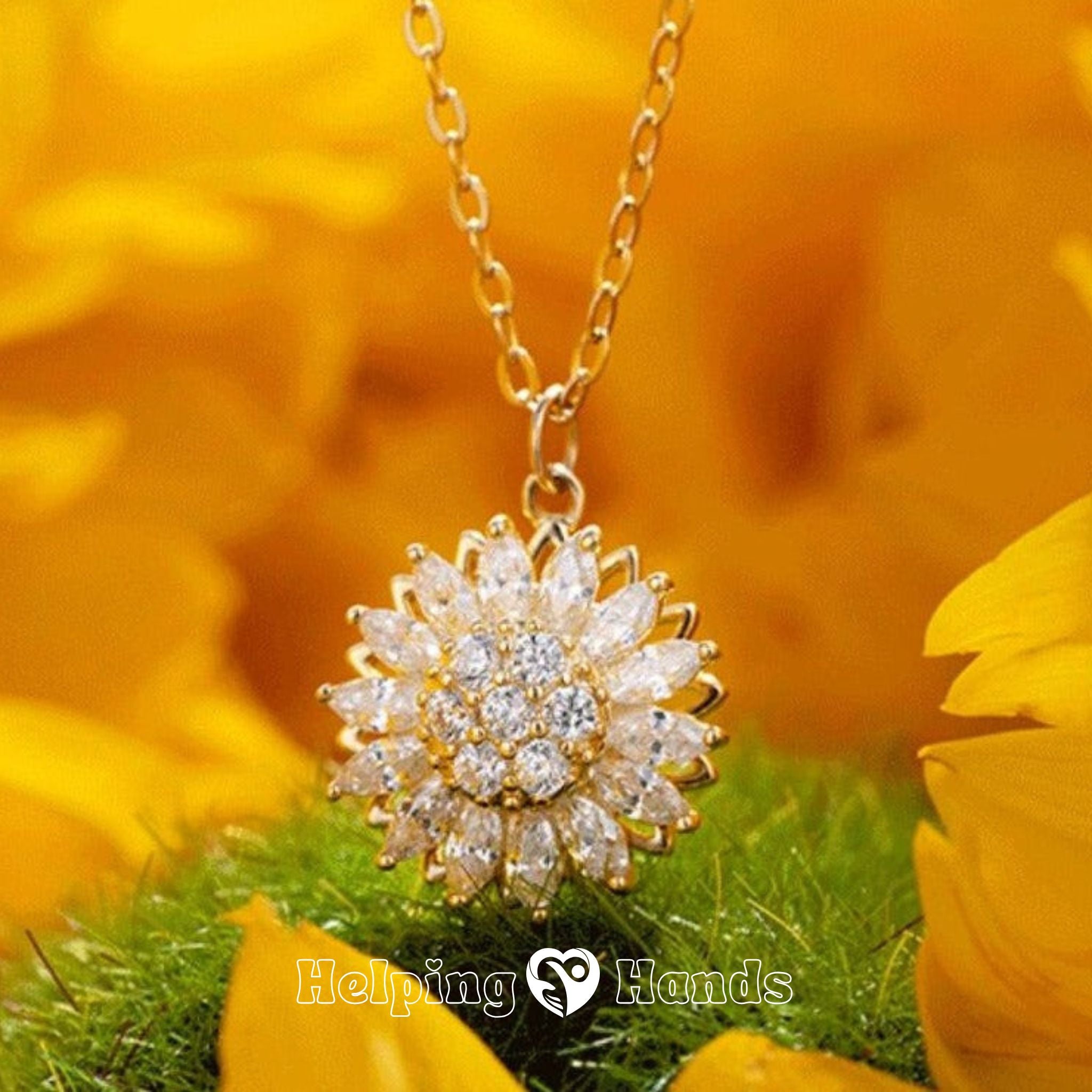 Gold necklace with a sunflower-shaped pendant against a yellow floral background