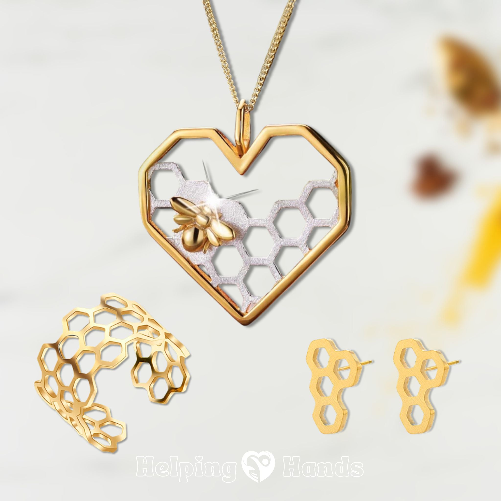 Gold jewelry set with heart-shaped pendant, ring, and earrings on a light background.