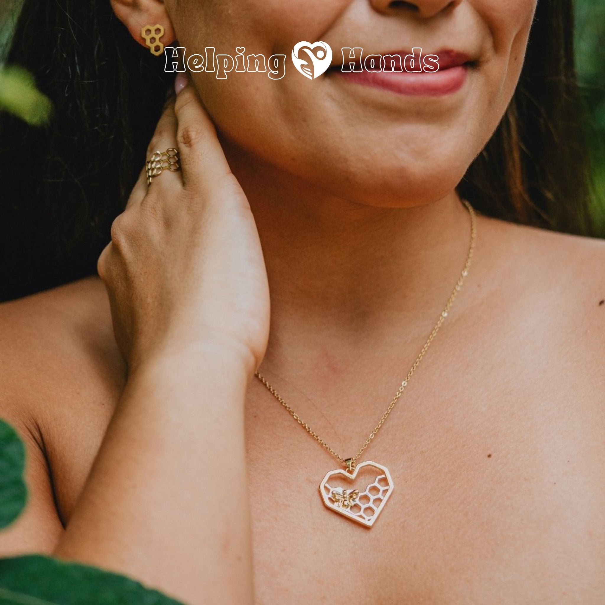 Woman wearing a gold necklace with a heart-shaped pendant.