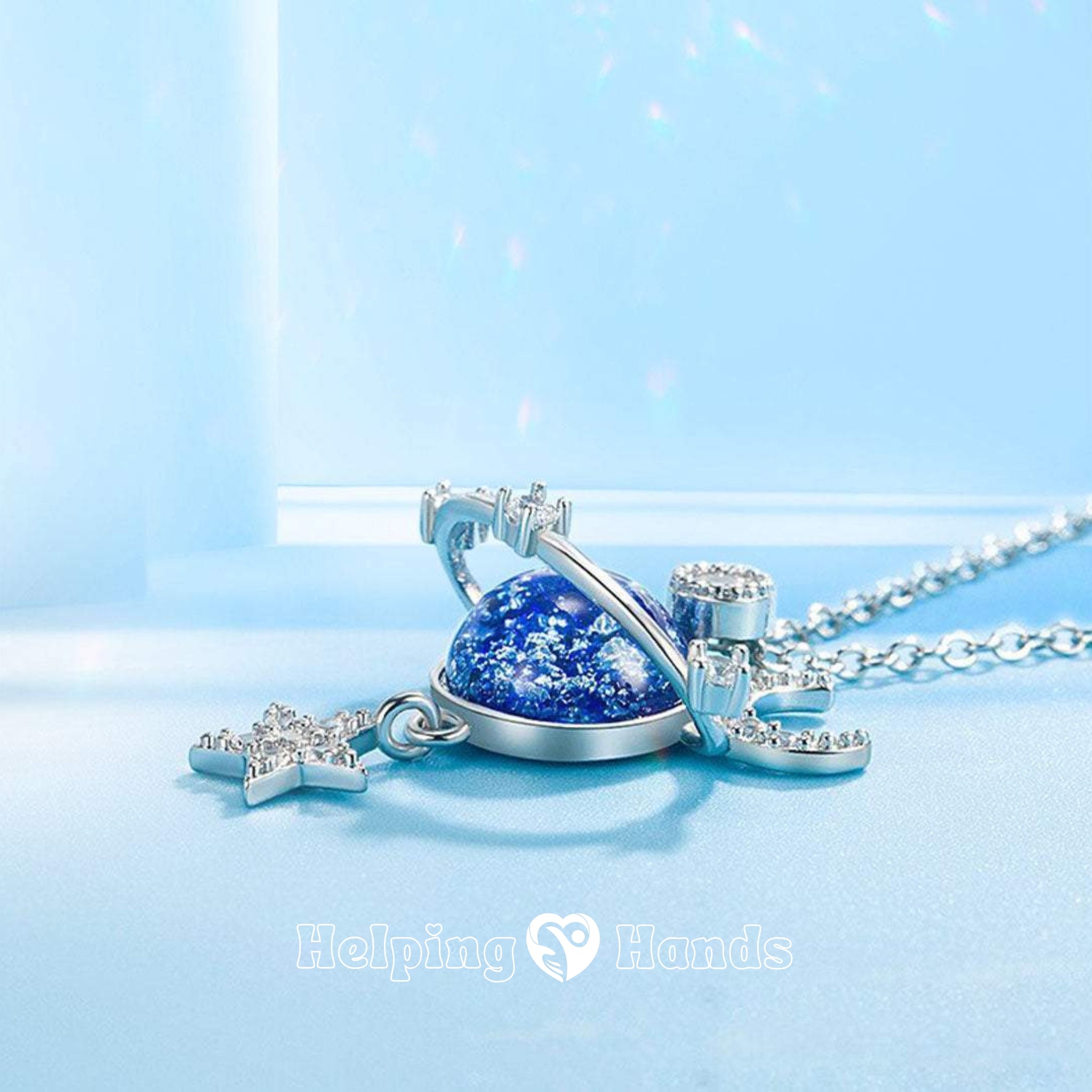 Sparkling blue planet necklace with crescent moon and star charms, accented with cubic zirconia – perfect celestial jewelry gift.

