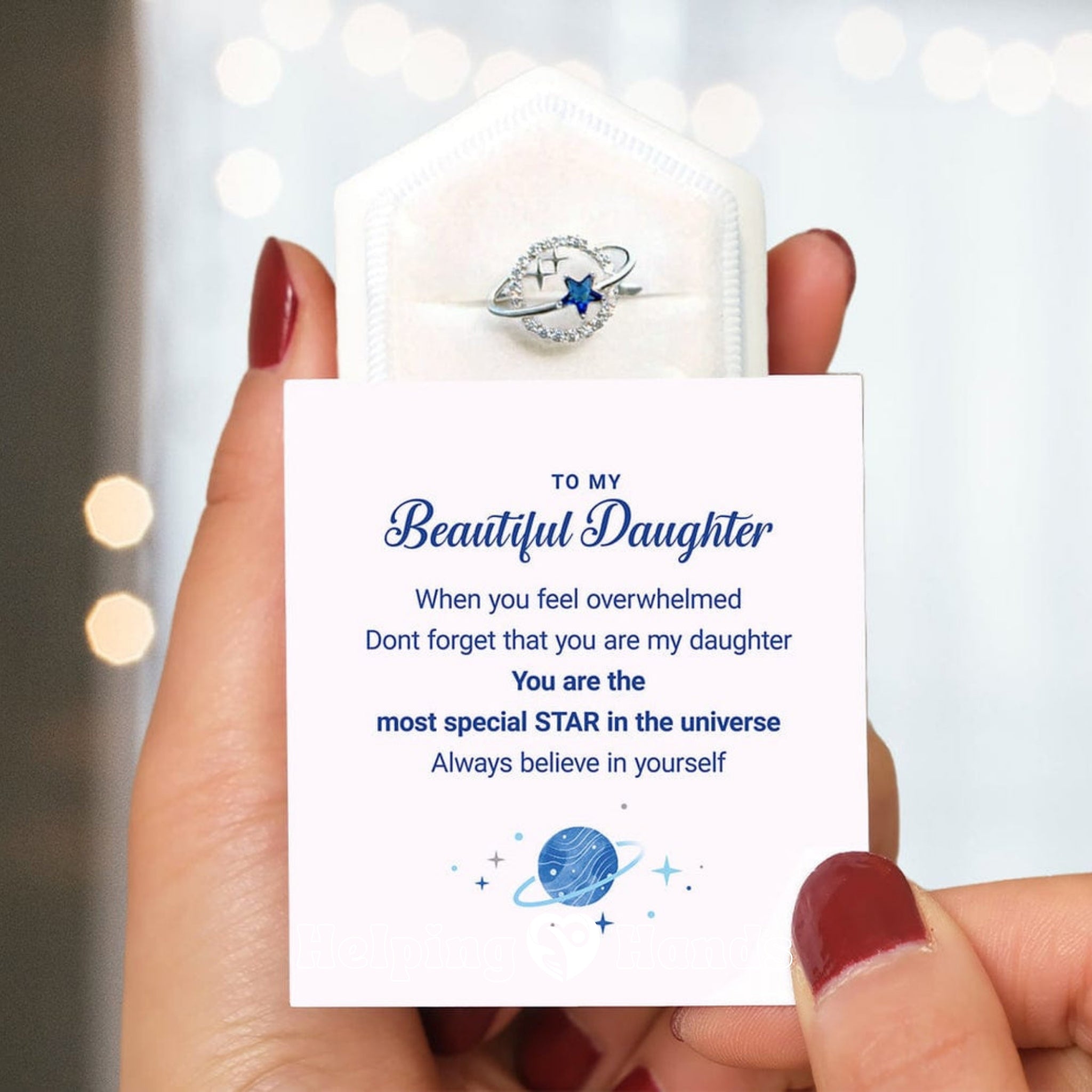 Elegant silver planet and star ring with blue crystal, presented on a heartfelt ‘To My Beautiful Daughter’ message card, inspiring confidence and love.

