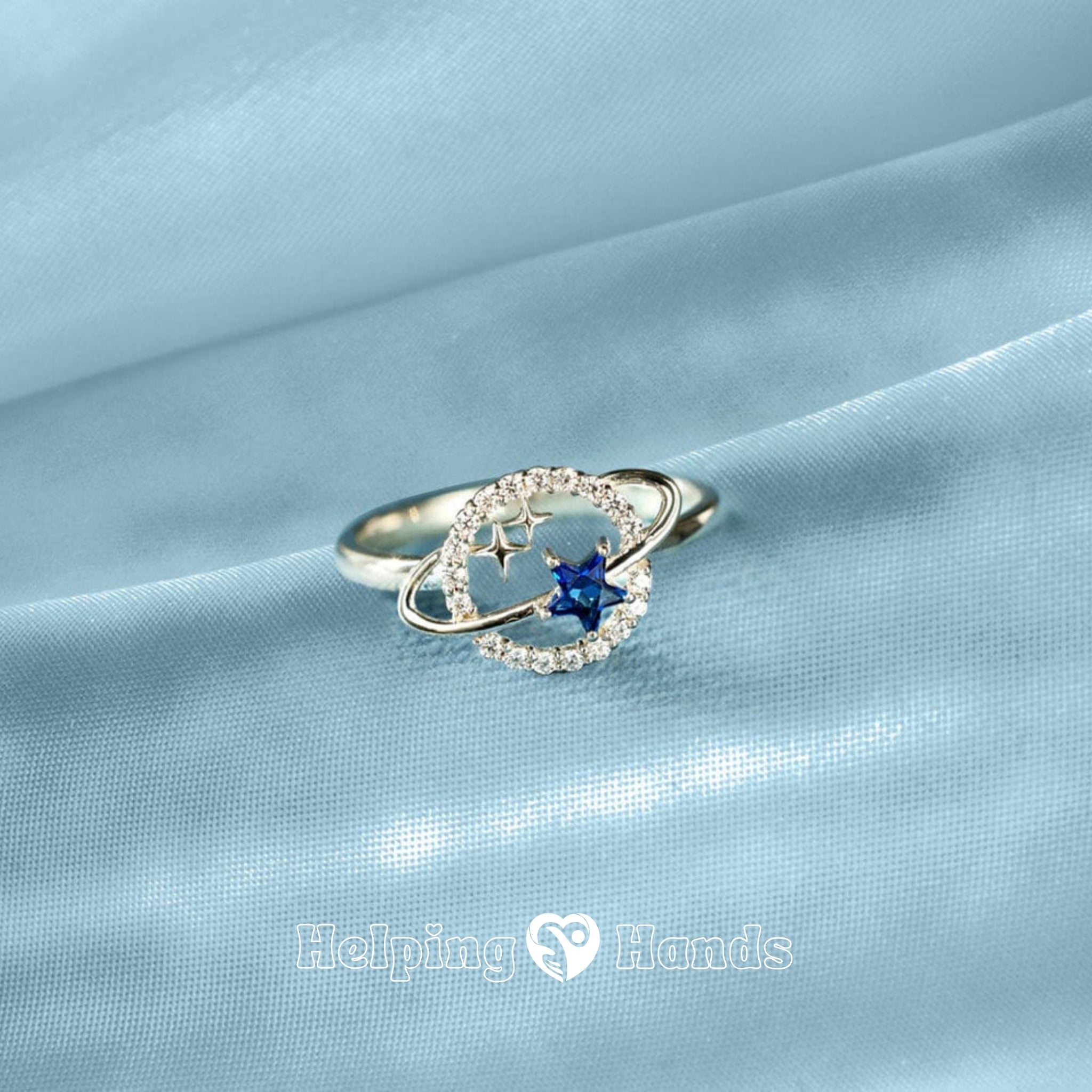 Beautiful star-themed ring with blue gemstone and orbit halo, accompanied by a motivational ‘To My Daughter’ keepsake card.

