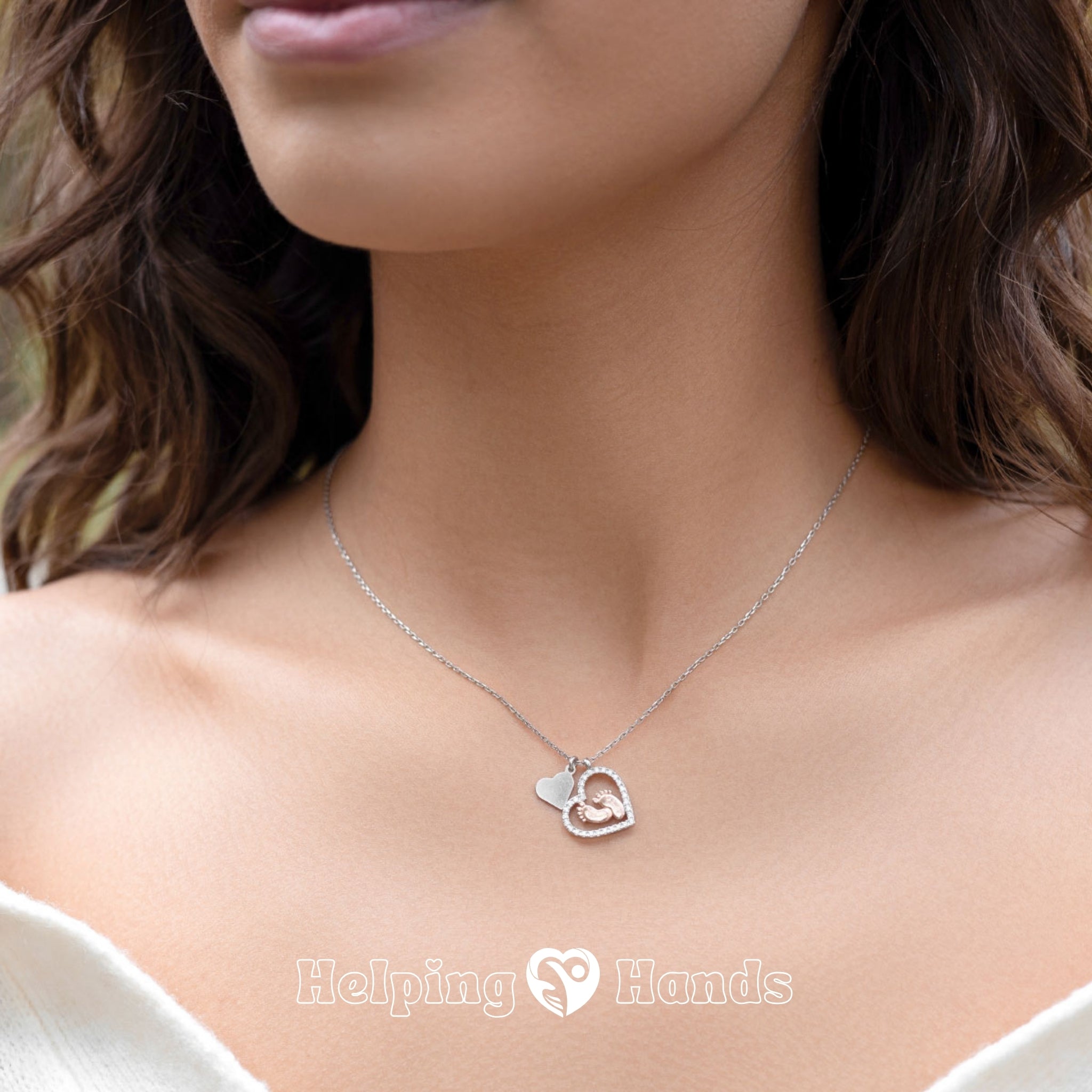 Sentimental maternity gift – silver heart pendant with baby feet charm, symbolizing love between mother and unborn child.

