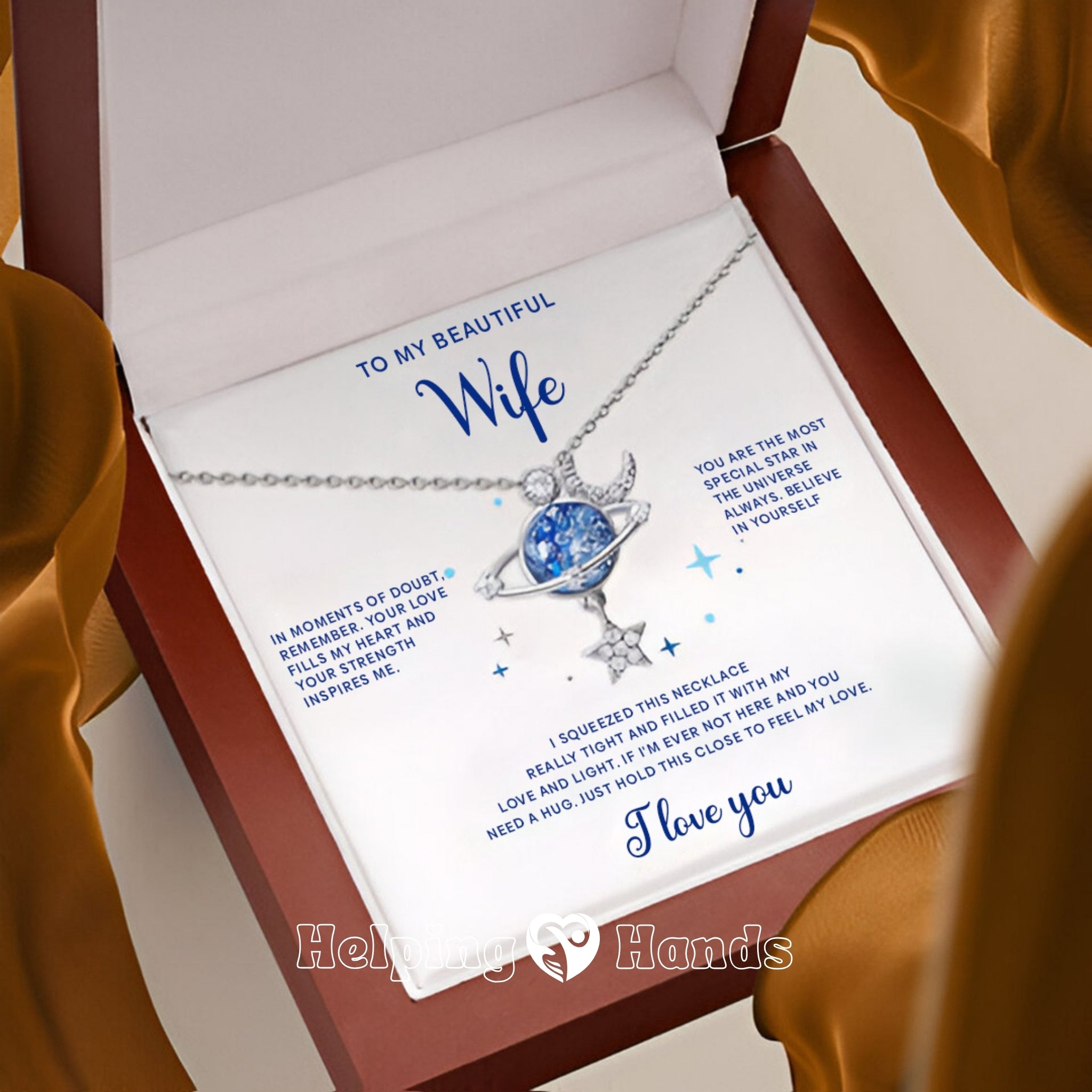 Galaxy-inspired pendant necklace featuring a blue planet, moon, and star design with cubic zirconia accents.

